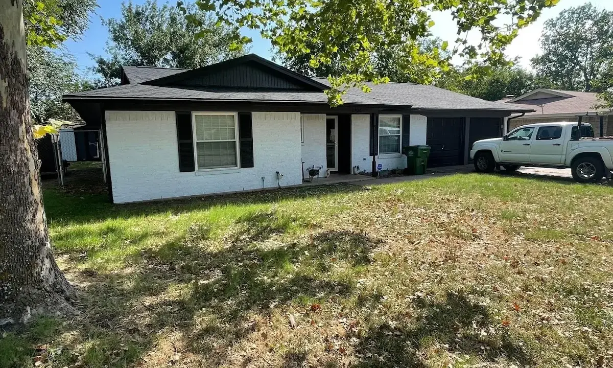 Professional roofing crew working on a residential roof in Wolcott